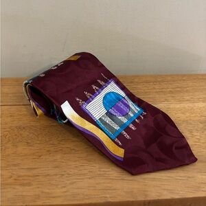 Damon silk tie with an abstract geometric pattern on a burgundy background
